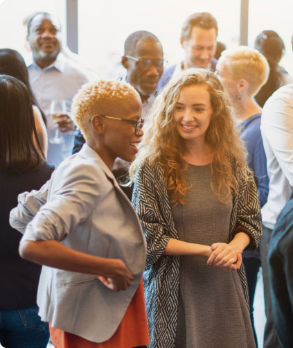 Group of educators smiling together at a community event